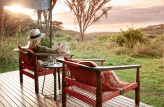 Guest relaxing on a private deck at sunset, Ngorongoro, Tanzania, Yellow Zebra Safaris
