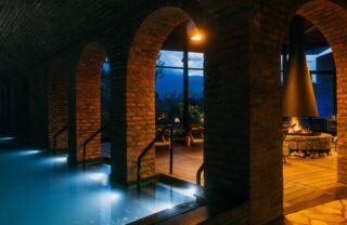 Sanctuary spa pool and fireplace at Bisate Reserve, Volcanoes National Park, Rwanda, Yellow Zebra Safaris
