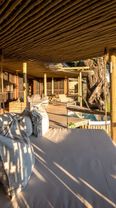 Exterior decking seating looking out onto the reserve, Mombo, Moremi Game Reserve, Botswana - Yellow Zebra Safari
