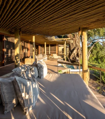 Exterior decking seating looking out onto the reserve, Mombo, Moremi Game Reserve, Botswana - Yellow Zebra Safari