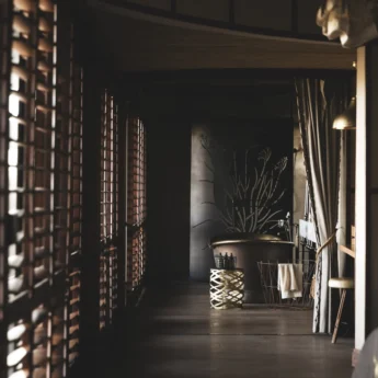 Hallway view down to a freestanding steel bath, Mombo, Moremi Game Reserve, Botswana - Yellow Zebra Safari