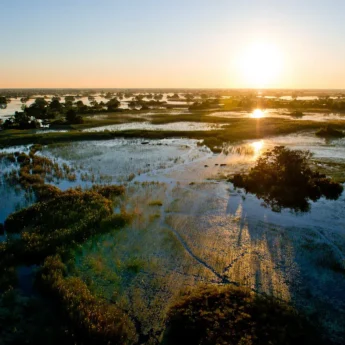 sunset over the okavango delta, botswana safari holidays