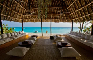 Indoor communal seating area looking out onto the ocean, Mnemba Island, Zanzibar, Tanzania - Yellow Zebra Safaris