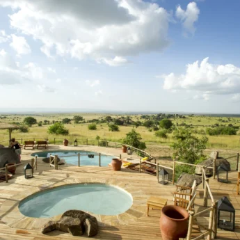 Two tiered pools set into decking which overlook the plains, Mkombe's House, The Serengeti, Tanzania - Yellow Zebra Safari