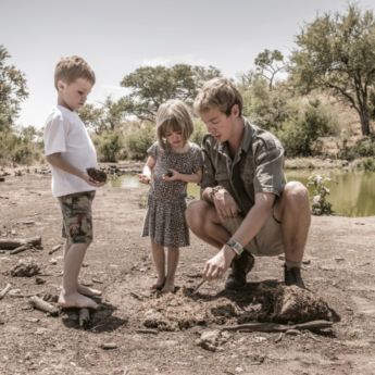 Safari Guide Teaching Plaster Casting to Children on Safari, Africa