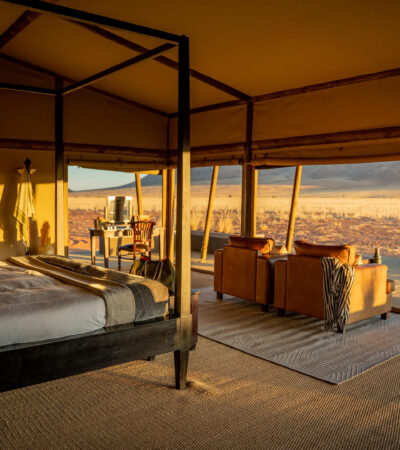 An interior view of the four poster bed which looks out onto the dunes, Wolwedans Plains Camp, Namibia - Yellow Zebra Safaris