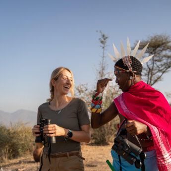 A man in tradition Samburu dress talks to a guest, Sarara Treehouses, Namunyak Conservancy, Kenya - Yellow Zebra Safari