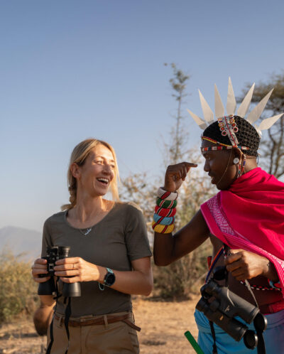 A man in tradition Samburu dress talks to a guest, Sarara Treehouses, Namunyak Conservancy, Kenya - Yellow Zebra Safari
