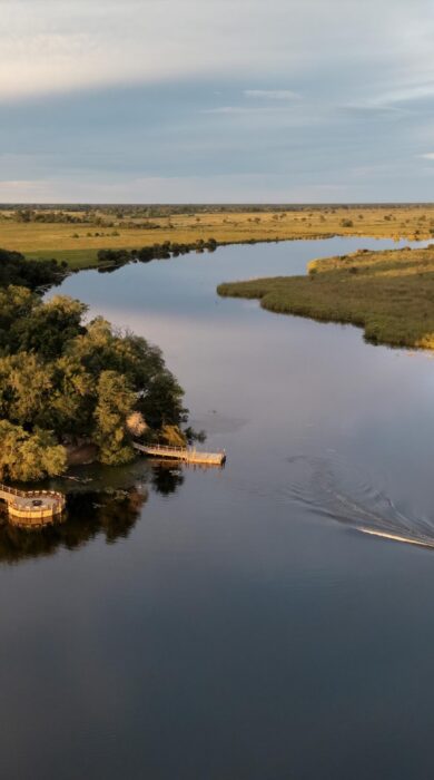 An aerial shot of a boat's river crossing, Camp Xugana Island Lodge, Okavango Delta, Botswana - Yellow Zebra Safaris