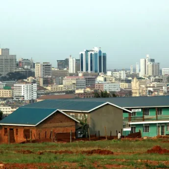View of Kampala, skyrises in the background and fields in the foreground, Kampala, Uganda - Yellow Zebra Safaris